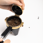 a person using a burr grinder 1
